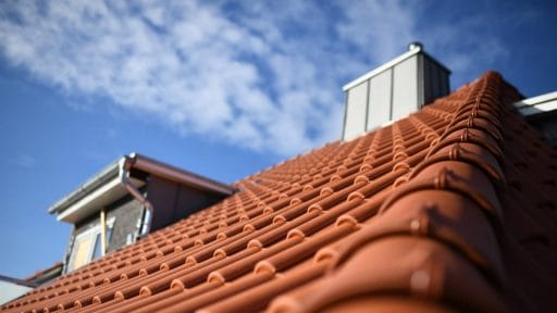 Clay tile roofing being inspected